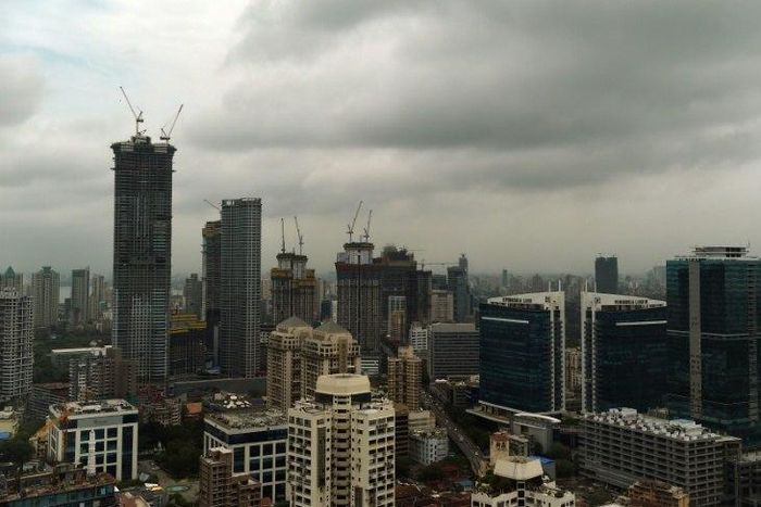 Dark clouds gather over India's financial capital of Mumbai during the monsoon season, when building collapses across the country become more common