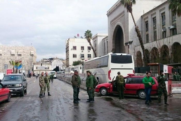 Syrian security forces cordon off the area following a suicide at a courthouse in Damascus on March 15, 2017