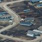 Aerial view of a residential neighborhood in Fort McMurray, Canada, where some homes have been rebuilt but many have not, one year after a massive forest fire