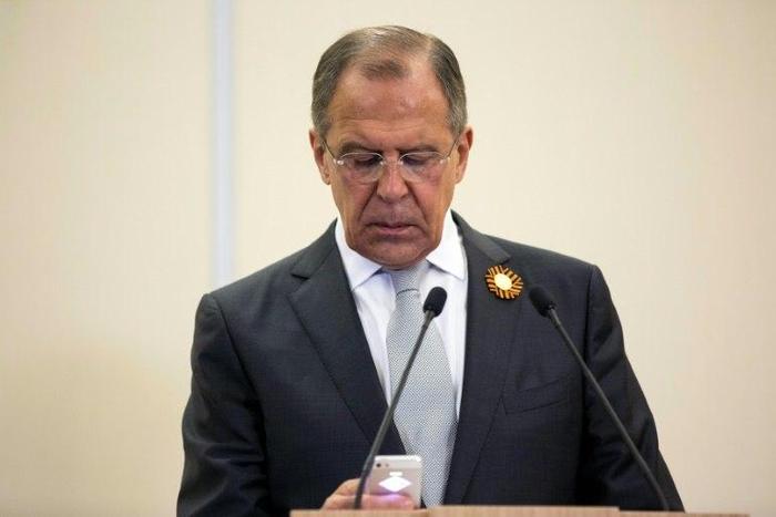 Russian Foreign Secretary Sergey Lavrov checks his smartphone during a 2015 press conference in Sochi, Russia