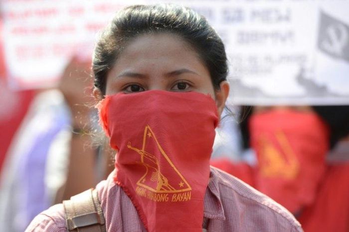 Members and supporters of the communist party of the Philippines' armed group, the New People's Army (NPA) march toward the peace arch for a protest near Malacanang Palace in Manila on March 31, 2017