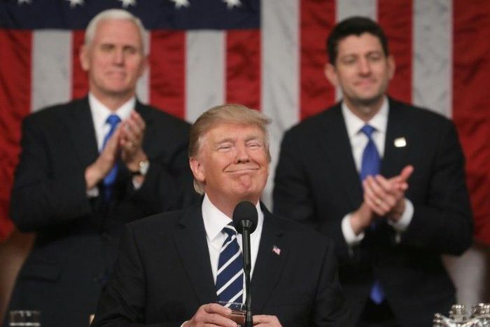 US Vice President Mike Pence (left) and House of Representatives Speaker Paul Ryan (right) applaud as President Donald Trump delivers his first address to a joint session of Congress
