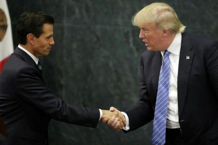 Mexican President Enrique Pena Nieto (L) and US presidential candidate Donald Trump shake hands after a meeting in Mexico City on August 31, 2016