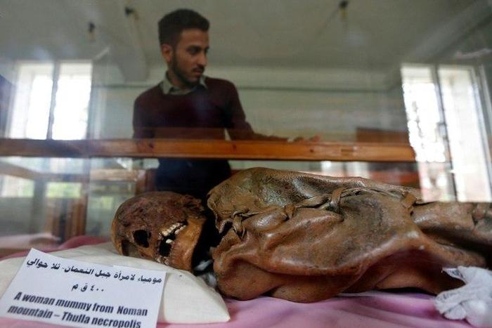 A Yemeni student looks at a millennia-old mummy on display at Sanaa University