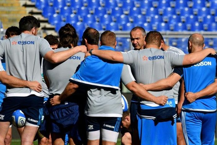 Italy's coach Conor O'Shea (R) speaks to players during a training session February 10, 2017
