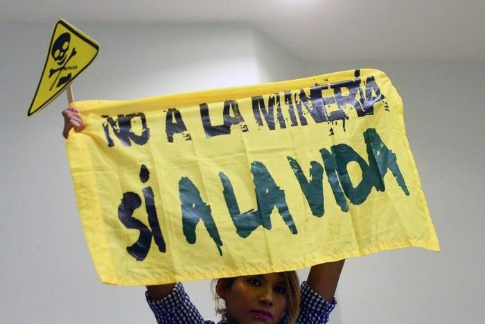 A woman holds a banner reading "No to mining. Yes to life" during a protest against mining at the Legislative Assembly in San Salvador on March 29, 2017