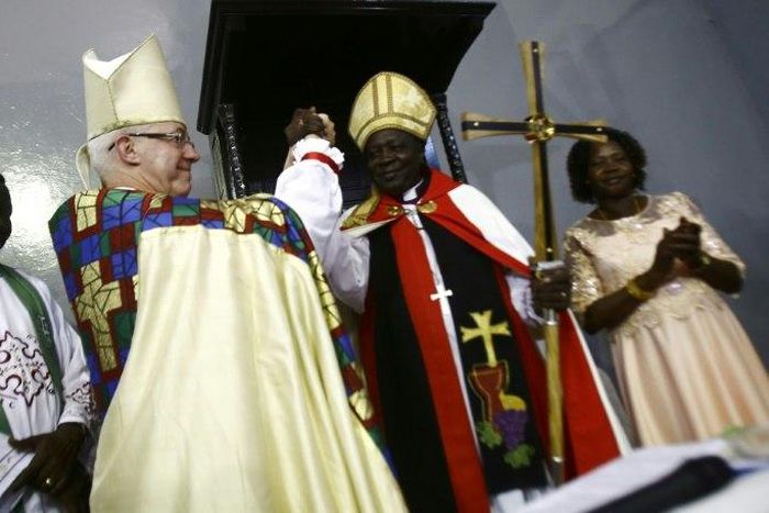 Archbishop of Canterbury Justin Welby and Ezekiel Kondo Kumir Kuku take part in a ceremony installing Kuku as Sudan's first archbishop at Khartoum's All Saints Cathedral on July 30, 2017
