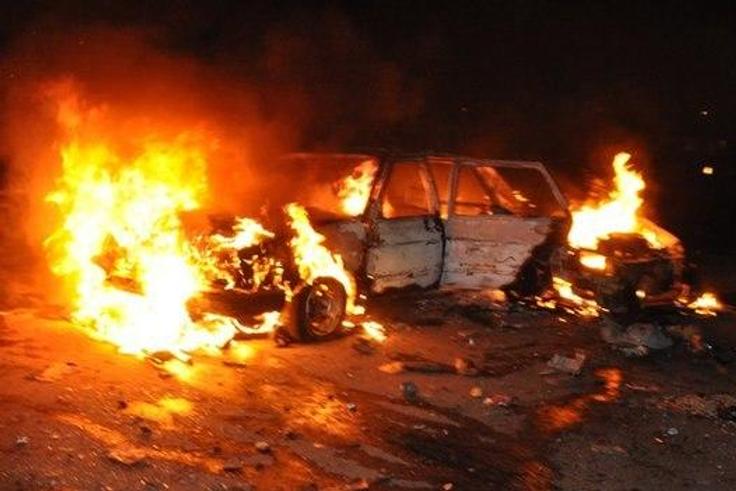 Car burns following a bomb blast in Abuja on 1 May 2014