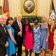 President Donald Trump with Joy Bishara and Lydia Pogu in the White House.