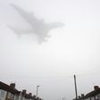 A Etihad Airways Airbus A380 comes in through the fog to land at Heathrow Airport in west London on December 30, 2016