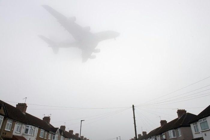 A Etihad Airways Airbus A380 comes in through the fog to land at Heathrow Airport in west London on December 30, 2016