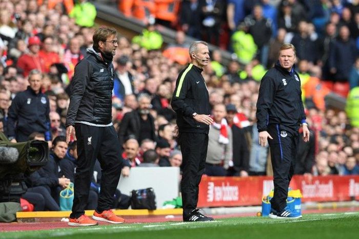 Everton manager Ronald Koeman (far right) looks at his Liverpool counterpart Jurgen Klopp during the Merseyside derby at Anfield in north-west England, on April 1, 2017