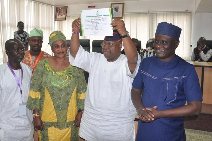 Otunba Ademola Adeleke raises his certificate of return above his head after it was presented to him by the Independent National Electoral Commission (INEC) on Tuesday, July 11, 2017