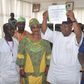 Otunba Ademola Adeleke raises his certificate of return above his head after it was presented to him by the Independent National Electoral Commission (INEC) on Tuesday, July 11, 2017