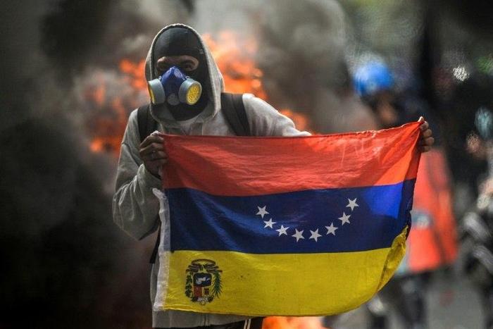 A hooded demonstrator protests against the government of President Nicolas Maduro in Caracas on May 31, 2017