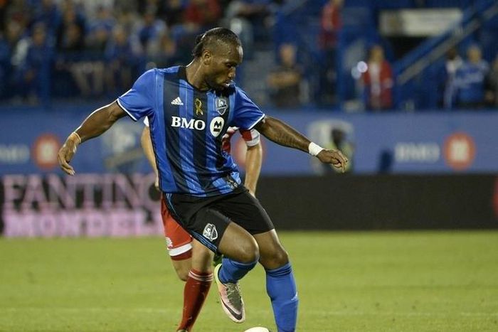 Montreal Impact forward Didier Drogba (11) dribbles the ball during the second half against the New England Revolution at Stade Saputo.
