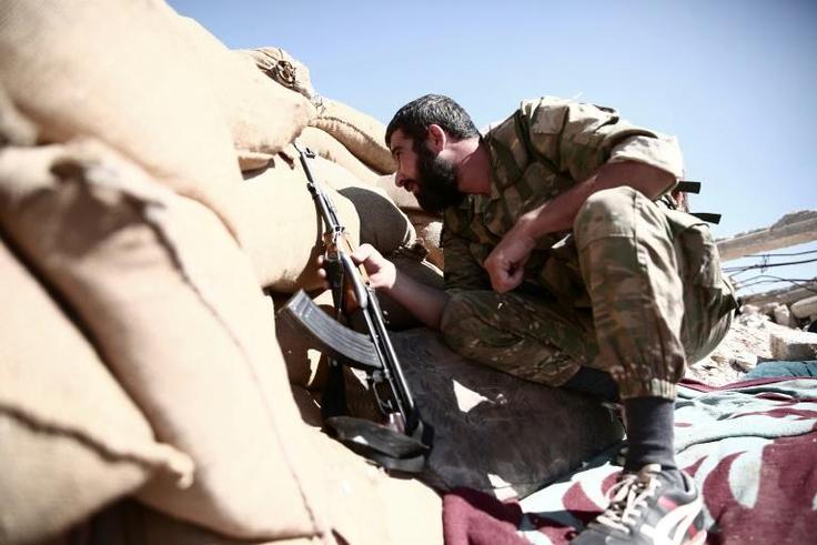 A fighter with rebel group Nureddine al-Zinki group mans a position in Syria's Aleppo province on September 23, 2018