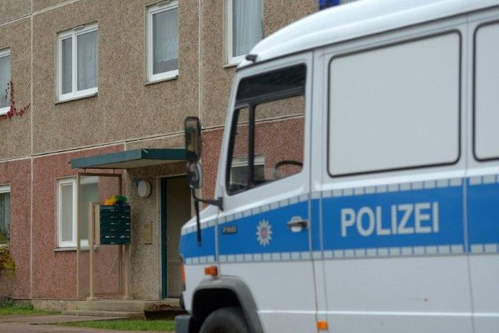 A police vehicle stands in front of a house in Suhl, east Germany, during an anti-terror operation on October 25, 2016