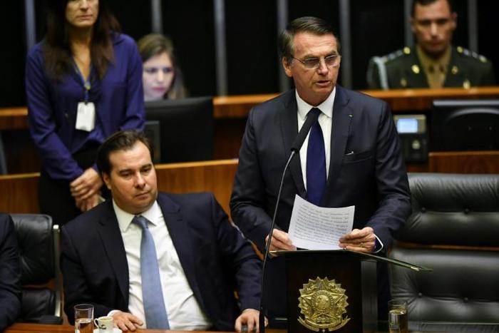 Jair Bolsonaro (R), standing next to Brazil's lower house president Rodrigo Maia, addresses Congress before being sworn in as Brazil's new president on January 1, 2019