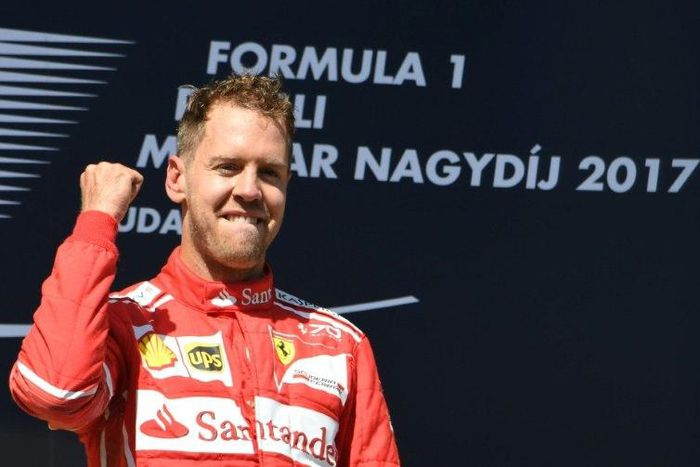 Ferrari's German driver Sebastian Vettel celebrates at the Hungaroring racing circuit in Budapest on July 30, 2017, after winning the Formula One Hungarian Grand Prix