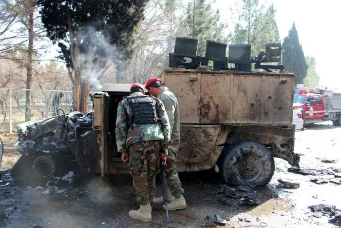 Afghan National Army (ANA) soldiers investigate a suicide car bomb attack in Lashkar Gah in Helmand Province on February 11, 2017