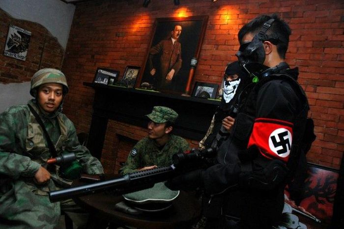A portrait of Adolf Hitler hangs in the SoldatenKaffee (The Soldiers' Cafe) on Java Island, where Indonesian customers would come dressed in WWII military uniforms