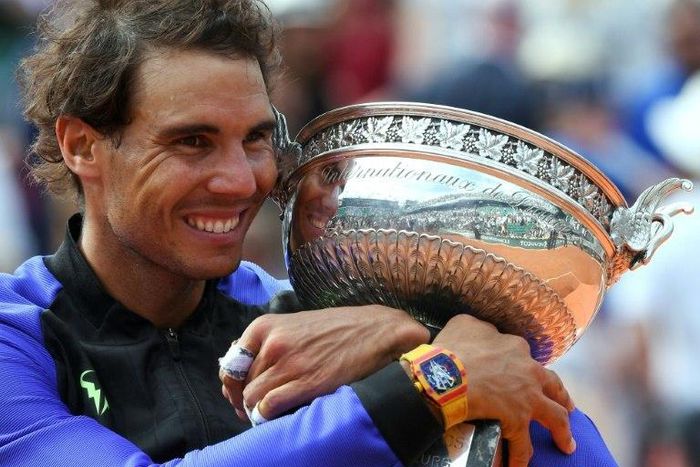 Spain's Rafael Nadal poses with the trophy after winning his 10th French Open title on June 11, 2017