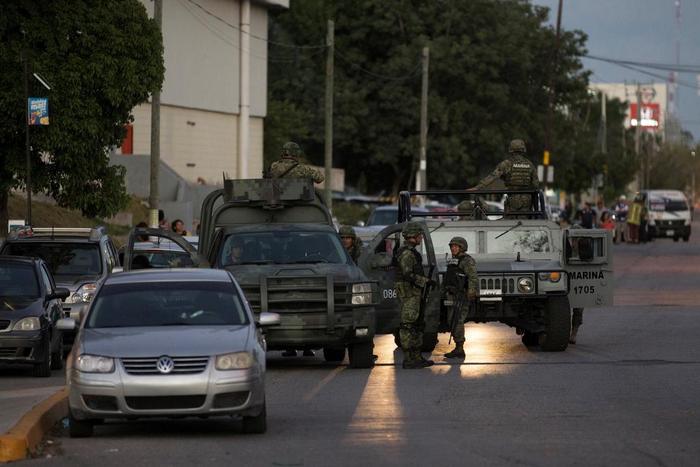 Soldiers guard the perimeter after an armed group shot at the attorney general's office, according to local media, in Cancun, Mexico, January 17, 2017.