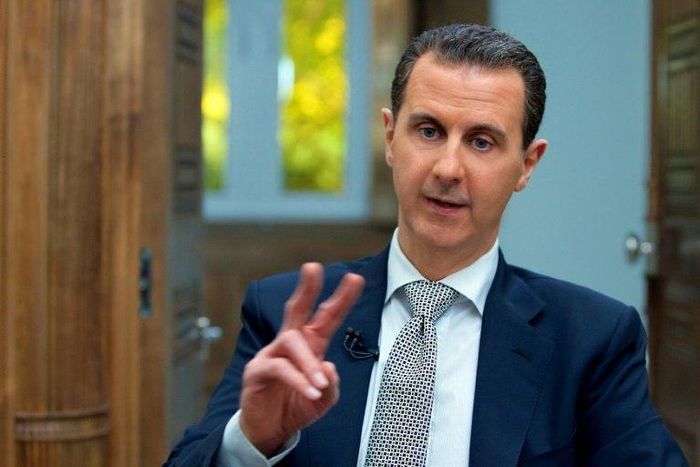 A handout picture released by the Syrian presidency's press office shows Syrian President Bashar al-Assad during an interview with AFP in the capital Damascus on April 12, 2017