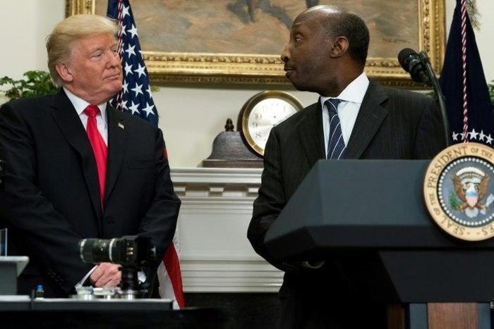Merck CEO Kenneth Frazier is seen here with President Donald Trump at a White House event in July.