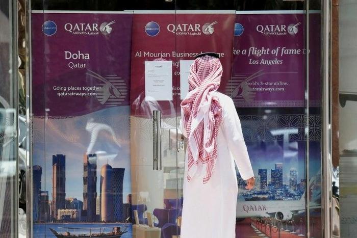 A man stands outside a Qatar Airways branch in the Saudi capital Riyadh, after it was forced to suspended all flights to Saudi Arabia