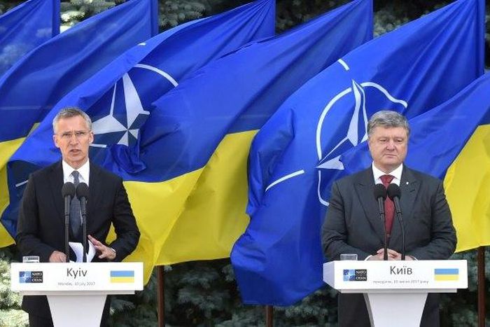 NATO chief Jens Stoltenberg (left) vowed at a press conference in Kiev with President Petro Poroshenko that the alliance stood by Ukraine