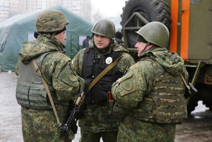 Ukrainian servicemen talk in the streets of Avdiivka, Donetsk region, on February 5, 2017