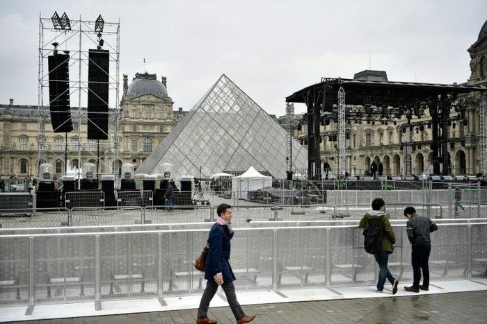 People walk through the courtyard of the Louvre following a security alert