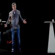 People sit near an hologram of French presidential election candidate Jean-Luc Melenchon (C) during a campaign meeting on February 5, 2017 in La Plaine Saint Denis, northern Paris