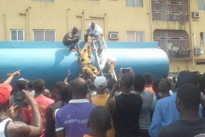The corpse of the fuel thief being removed from the petrol tanker