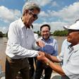 US Secretary of State John Kerry (L) shakes hands with Vo Ban Tam, 70, who was a member of the former Viet Cong guerrilla and who took part in the attack on Kerry's Swift Boat on February 28, 1969
