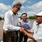 US Secretary of State John Kerry (L) shakes hands with Vo Ban Tam, 70, who was a member of the former Viet Cong guerrilla and who took part in the attack on Kerry's Swift Boat on February 28, 1969