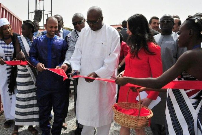 President of Burkina Faso Roch Marc Christian Kabore (C) cuts the ribbon during the inauguration of a new movie theatre which runs on solar power in Ouagadougou on February 24, 2017