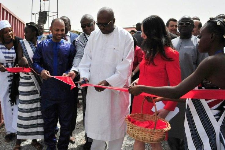 President of Burkina Faso Roch Marc Christian Kabore (C) cuts the ribbon during the inauguration of a new movie theatre which runs on solar power in Ouagadougou on February 24, 2017