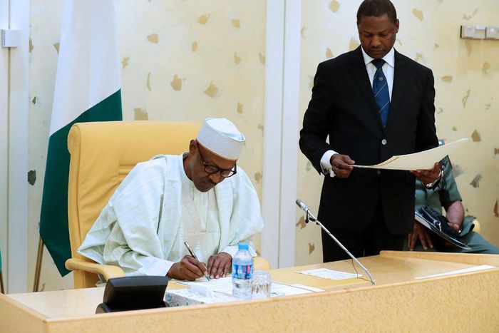 President Muhammadu Buhari signing documents in Abuja on Thursday, August 24, 2017