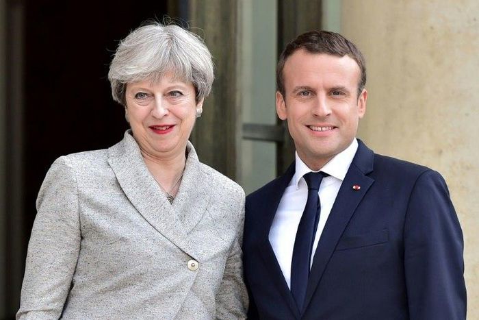 Britain's Prime Minister Theresa May (L) is greeted by France's President Emmanuel Macron ahead of a meeting at The Elysee Palace in Paris on June 13, 2017