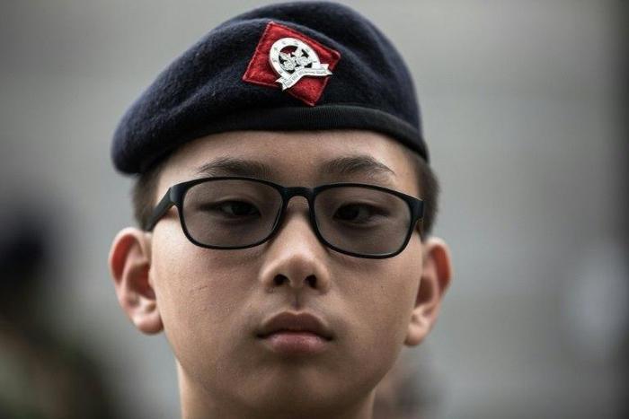 Cadets from the Hong Kong Adventure Corps wear green camouflage and berets and learn everything from map-reading to abseiling