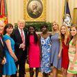 President Donald Trump with Joy Bishara and Lydia Pogu in the White House
