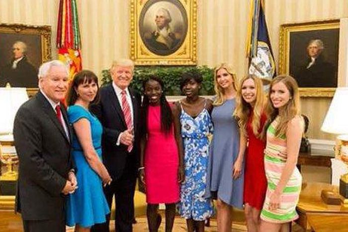 President Donald Trump with Joy Bishara and Lydia Pogu in the White House