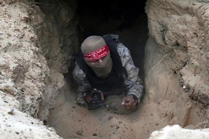 A Palestinian militant of the National Resistance brigades gets out of a tunnel in Rafah, in the southern Gaza Strip
