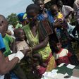 Members of the NGO Doctors Without Borders distribute medicine against malaria on the outskirts of Bambari, in 2014