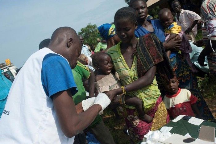 Members of the NGO Doctors Without Borders distribute medicine against malaria on the outskirts of Bambari, in 2014