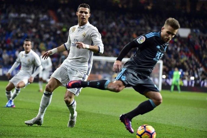 Real Sociedad's Kevin Rodrigues (R) controls the ball next to Real Madrid's Cristiano Ronaldo during their Spanish La Liga match, at the Santiago Bernabeu stadium in Madrid, on January 29, 2017