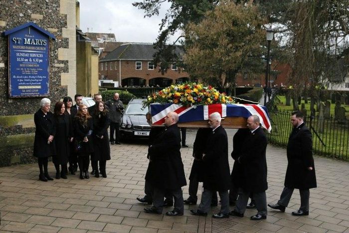 Rita Taylor (L), the wife of former England manager and manager of Watford football club Graham Taylor watches as his coffin is brought into church during his funeral service in Watford on February 1, 2017
